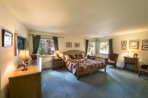 a bedroom with a bed and a table and chairs at Wawona Home in Wawona