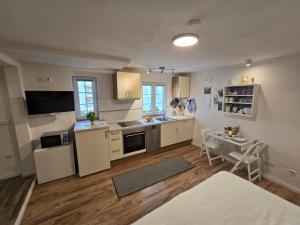 a kitchen with white cabinets and a table in it at Ferienwohnung Casa Orlandini in Bad Reichenhall