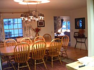 a dining room with a wooden table and chairs at Wawona Home in Wawona