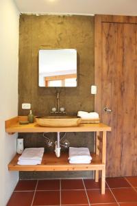 a bathroom with a wooden sink and a mirror at Casa Ecológica Al Pie Del Volcán in Otavalo +27 photos