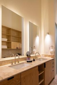 a bathroom with two sinks and a large mirror at HOLT Parque Juarez Privada Stunning 5BR Villa in San Miguel de Allende +64 photos