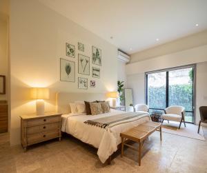 a bedroom with a bed and a large window at HOLT Parque Juarez Privada Stunning 5BR Villa in San Miguel de Allende