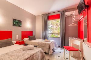 Postel nebo postele na pokoji v ubytování Hostal Tropical