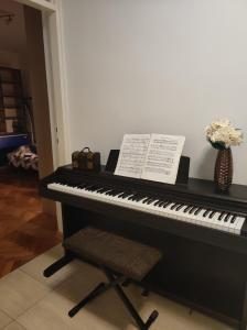 Czarny fortepian z prześcieradłem w obiekcie Apartment Nicola w mieście Mostar