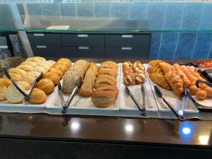 a bunch of different types of breads and pastries at Median Hotel Hannover Lehrte in Lehrte