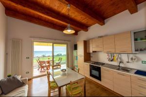 a kitchen and dining room with a table and chairs at Appartamenti Adriatico & Gran Sasso in Pineto