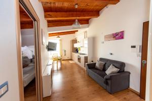 a living room with a couch and a bedroom at Appartamenti Adriatico & Gran Sasso in Pineto