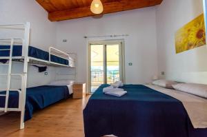 a bedroom with two bunk beds and a balcony at Appartamenti Adriatico & Gran Sasso in Pineto