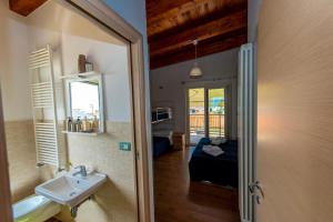 a bathroom with a sink and a room with a bed at Appartamenti Adriatico & Gran Sasso in Pineto +95 photos