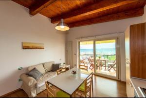 a living room with a couch and a table at Appartamenti Adriatico & Gran Sasso in Pineto