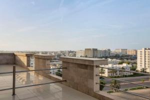 a view of the city from the balcony of a building at Levatio Suites Muscat, a member of Radisson Individuals in Muscat