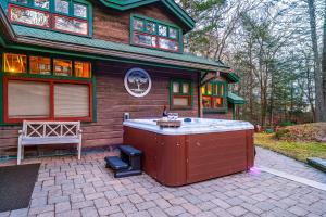 a house with a hot tub in front of it at Stunning Couples Retreat Lodge in Milford