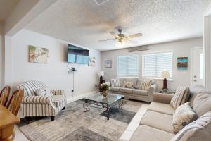 a living room with couches and a table at Sugar Beach D17 in Navarre