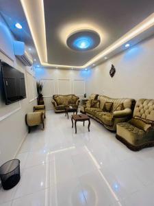 a living room with couches and a flat screen tv at شقق خزامى الباحة in Al Baha