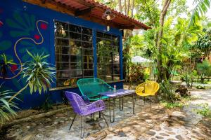 a table and chairs in front of a blue building at Amaranto Hostel in Panajachel