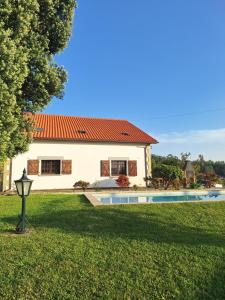 a house with a swimming pool in a yard at LIMA COTTAGES - Casa de S Tiago in Ponte de Lima