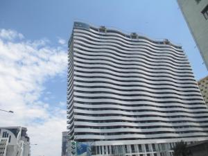 a tall building with many windows in a city at Orbi Residence 22 Floor in Batumi