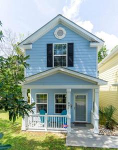 a blue house with two chairs on the porch at 2 Bedroom Coastal Cottage 1 block to the beach in Myrtle Beach