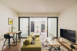 a living room with a couch and a tv at Island Bliss in Ponta Delgada