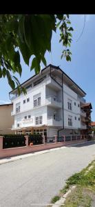 a large white building on the side of a street at Vila Bolonja in Struga