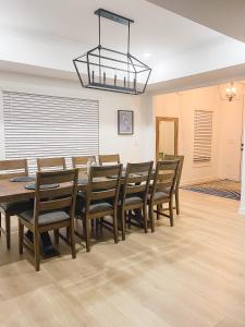 a dining room with a table and chairs at 5 Star 4/3 sleeps 16 with Arcade GAME ROOM & POOL! in Orange Beach