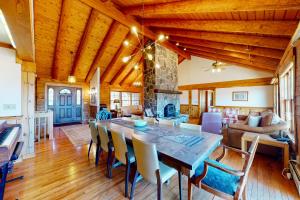 a dining room and living room with a table and chairs at Summit Solitude in Franconia