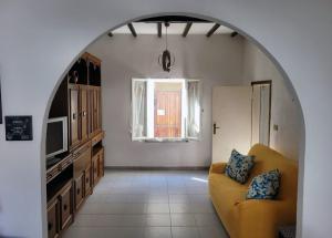 a living room with a yellow couch and a window at SeaDream Appartamento Follonica in Follonica