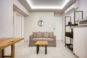 salon z kanapą i stołem w obiekcie Pagrati/Hilton area, Bentzi (3) Boutique Apt. for 4 w Atenach