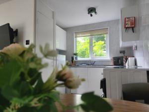 a kitchen with a table and a window at Hayle holiday cottage in Hayle
