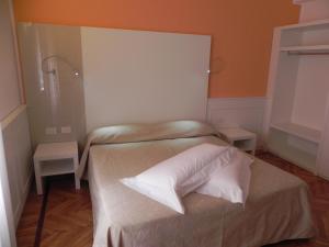 a small bedroom with a bed with two tables at Affittacamere Via Mazzini in Stresa