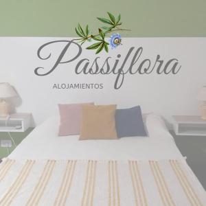 a bedroom with a bed with a sign on the wall at Alojamiento Passiflora I in Villa Elisa