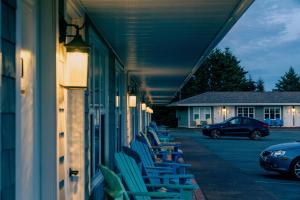 a row of chairs sitting on the side of a building at North Rustico Harbour Inn in North Rustico +9 photos