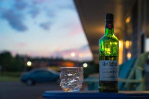 a bottle of wine sitting on a table next to a glass at North Rustico Harbour Inn in North Rustico