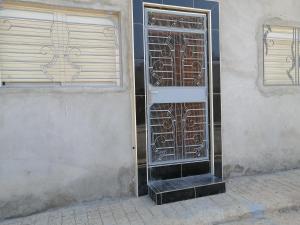 a building with a door on the side of it at Bokidan appartement in Andalouciene +2 photos