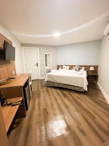 a large bedroom with a bed and wooden floors at Athos Hotel in Teresópolis +39 photos