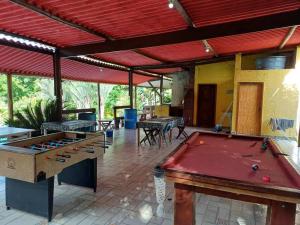 a patio with a pool table and tables at Chácara fortes em Pindamonhangaba in Pindamonhangaba