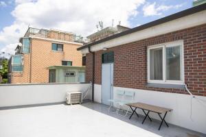 a balcony with a table and chairs on a building at Chuls lodge in Seoul