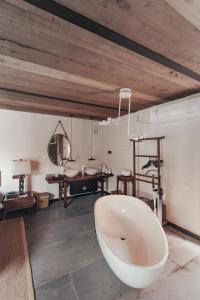 a large bathroom with a bath tub and a table at Zhangjiajie Song Boutique B & B - Zhangjiajie National Forest Park Wulingyuan in Zhangjiajie