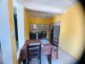 a kitchen with a wooden table and two chairs at Casa Mama Wela in San Pedro La Laguna +9 photos
