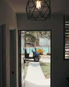 a scooter parked in the driveway of a house at Villas Boqueyé in Cabo Rojo +13 photos