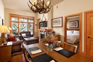 a living room with a dining table and a bedroom at Alpine Luxury Escape At Capitol Peak Lodge in Snowmass Village
