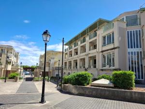 a street light in front of a building at Appartement avec Piscine, Tennis & Balcon, Centre-ville Chatelaillon-Plage, 6 Pers, 2 Ch - FR-1-706-17 in Châtelaillon-Plage