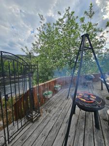 a hammock on a deck with a fire grill at Holiday Riverside Beach Camping in Gol