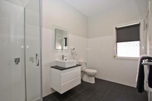 a white bathroom with a sink and a toilet at Jesmond Affordable Apartments in Jesmond +12 photos