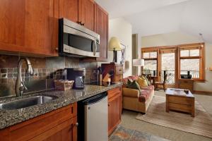 a kitchen with a sink and a microwave at Summertime Sanctuary Top-floor Mountain Studio in Snowmass Village