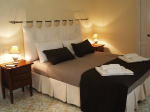 a bedroom with a large bed with two night stands at Sine Tempore B&B in Manduria +91 photos