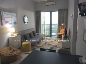 een woonkamer met een bank en een tafel bij Tamarind Suites or D'Pulze Residence or Domain NeoCyber, click Room selection for location and pics in Cyberjaya