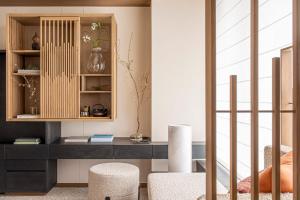 a living room with a desk and chairs at Four Seasons Hotel Osaka in Osaka