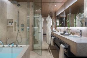 a bathroom with a shower and a sink and a tub at Four Seasons Hotel Osaka in Osaka +84 photos
