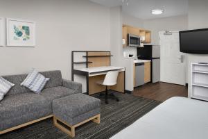 a living room with a couch and a table and a kitchen at TownePlace Suites Sacramento Cal Expo in Sacramento